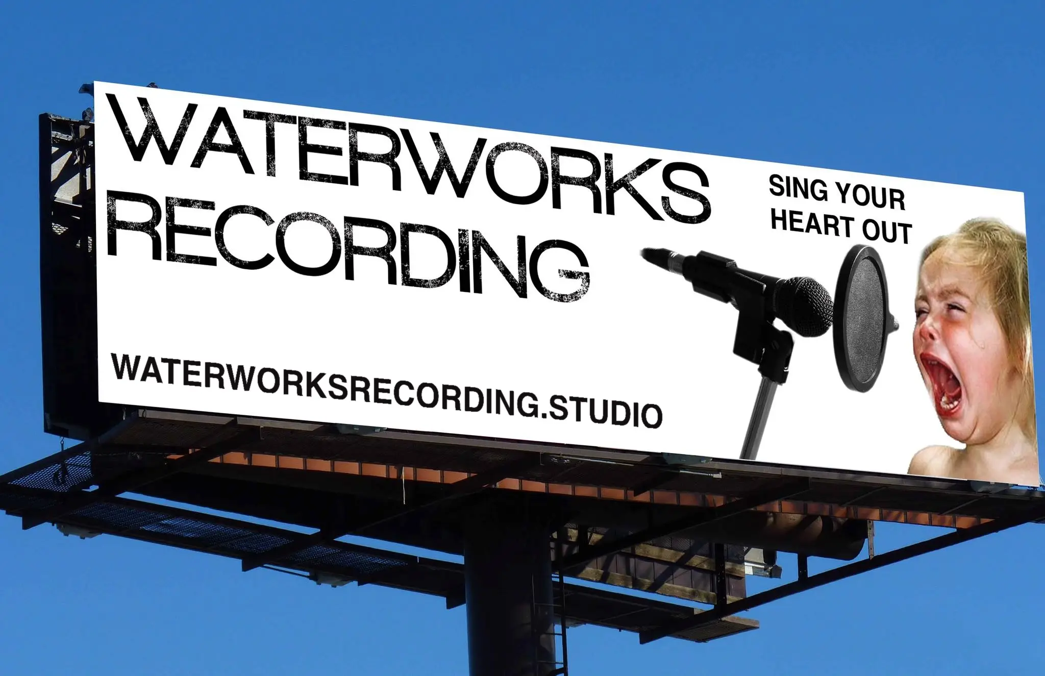 Roadside billboard against a blue sky: Waterworks Recording, Sing Your Heart Out, with a microphone and a screaming toddler.